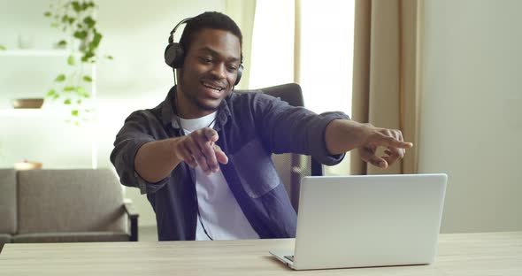 Black Mixed Race African Businessman Student Lonely Guy Sitting at Table in Home Office Watching