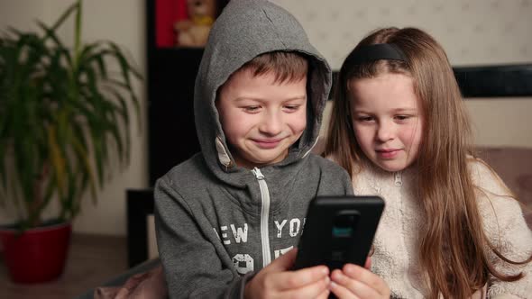 Amazed Children Watching Smart Phone Happy Young Kid Smartphones Together