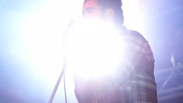 Singer performing on stage at a concert 4k