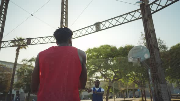 Cinematic footage of a street basketball game outdoor.