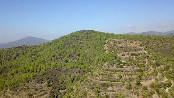 Aerial drone shot flying over forest mountains in Cyprus