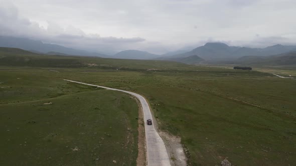 Aerial Shot of Car Driving In The Wild