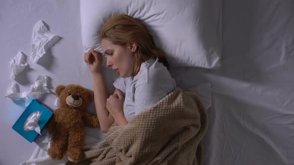 Depressed Woman in Bed Crying, Hugging Teddy-Bear, Suffering From Miscarriage