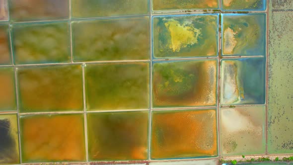 An aerial view from a drone flying over a salt fields, salt production.