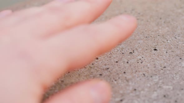 Young Man Hand Touching Concrete Wall