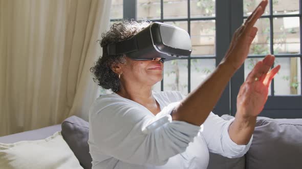 Senior mixed race woman wearing a vr headset. Social distancing and self isolation in quarantine