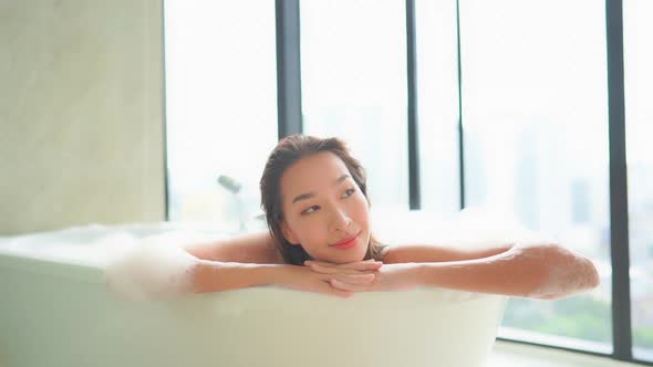 Young asian woman relax in bathtub