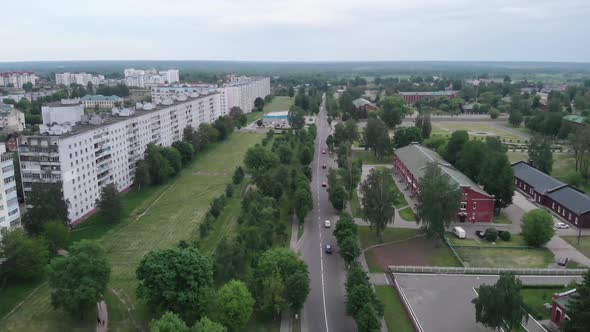 Aerial View of Long Multistorey Panel Houses and City Blocks Among the Trees Against the Background