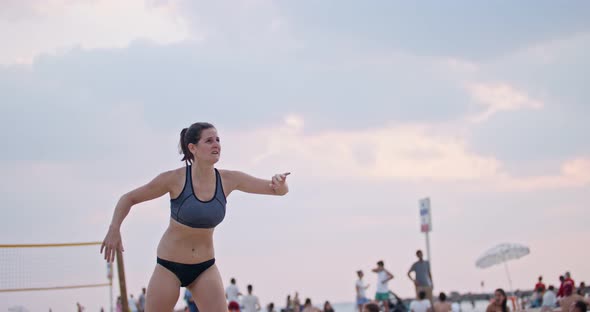 Slow motion of women playing beach volleyball during sunset