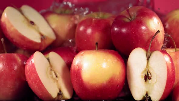 Slow Motion Shot of Red Apple Water Splashing Through Apple Slices