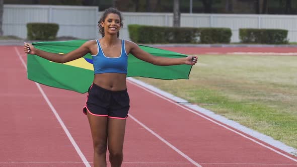 Young Participant of Sports Competition Holding Brazil Flag and Enjoying Victory