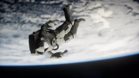 Astronaut Floating Above the Earth Elements of This Image Furnished By NASA