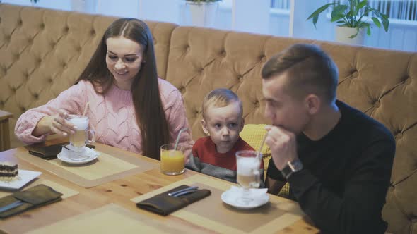 Happy Family Taste Beverages in Restaurant with Pot Plant
