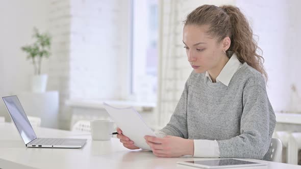 Focused Young Latin Woman Checking Financial Documents