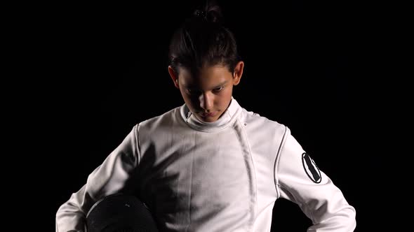 Portrait of a Young Guy Fencer Raising His Head and Looking at the Camera