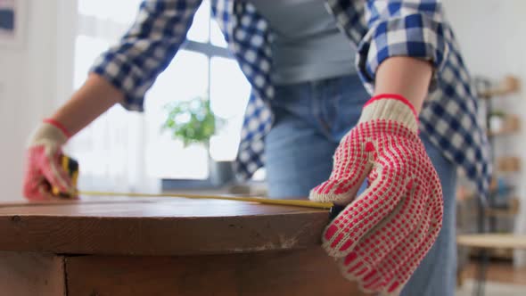 Woman with Ruler Measuring Table for Renovation