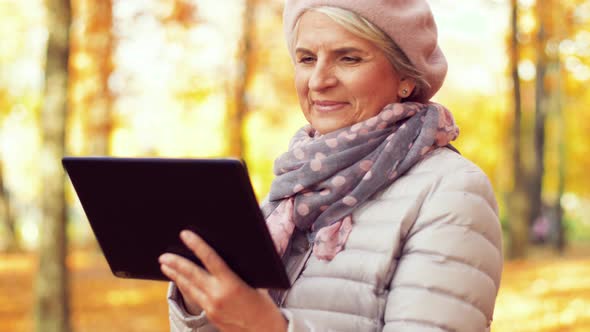 Senior Woman with Tablet Pc at Summer Park