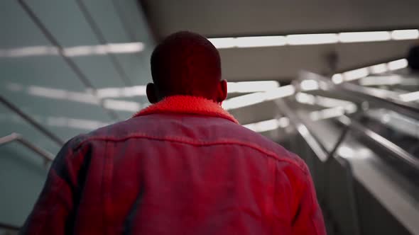 Black man climbing stairs in subway