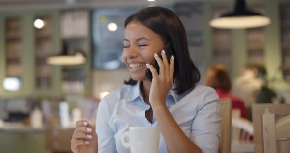 African Young Businesswoman Calling Using Smartphone Relaxing at Cafe