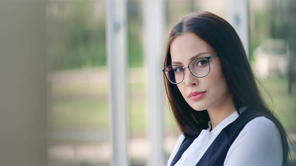 Portrait Beautiful Young Successful Businesswoman in Glasses Calm and Thoughtful Looking at Camera