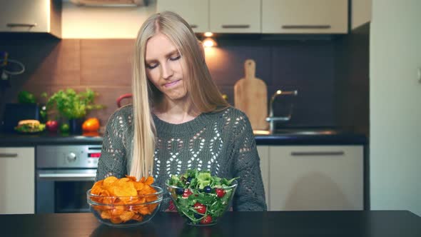 Young Lady Preferring Crisp To Salad.