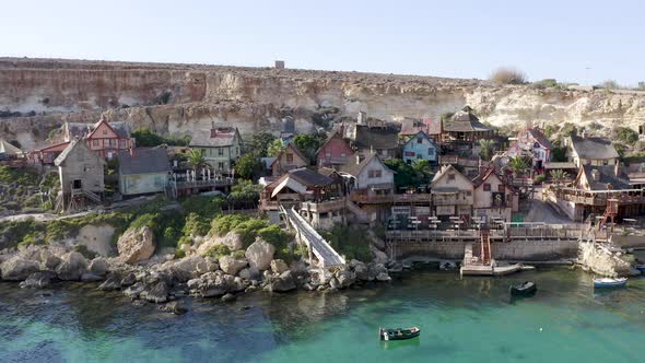 Picturesque Popeye Village theme park on a rocky shore,Malta,aerial.