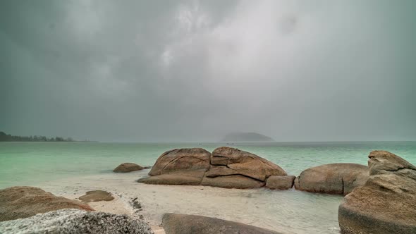 Storm with Heavy Tropical Rain on the Background of Rocky Stones and Sea Landscape