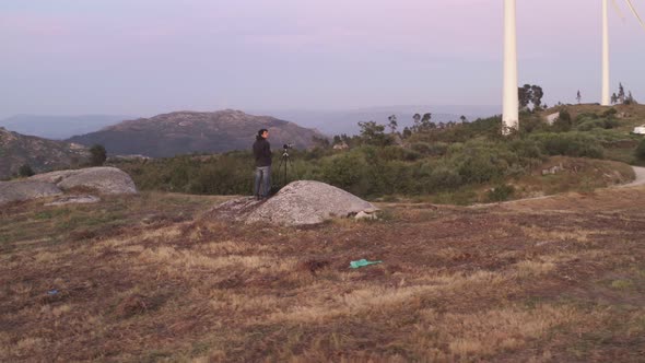 Photographer in Casa do Penedo drone aerial view in Fafe with wind turbine, Portugal