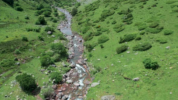 River flowing through valley in mountains