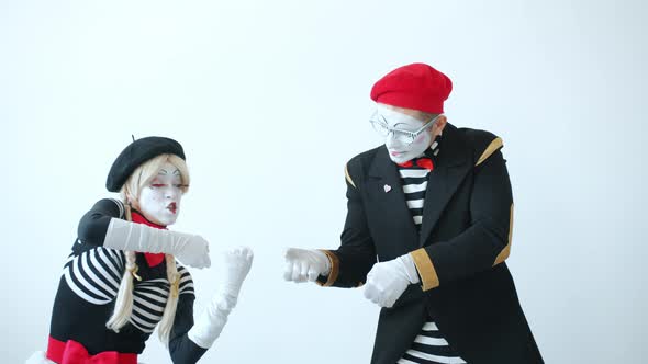 Male and Female Mimes Pulling Imaginary Rope Then Falling After Crazy Competition