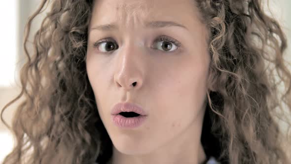 Face Close Up of Amazed Curly Hair Woman