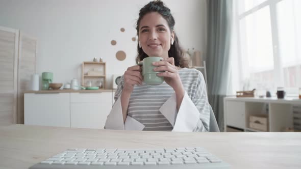 Woman Microwave Food while Having Online Meeting