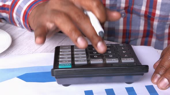 Close Up of Man Hand Using Calculator 