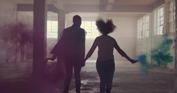 Fashionable young man and woman in an abandoned warehouse