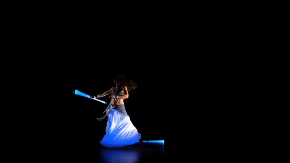 Beautiful Woman Dance With Neon Staffs In Ultraviolet Light 