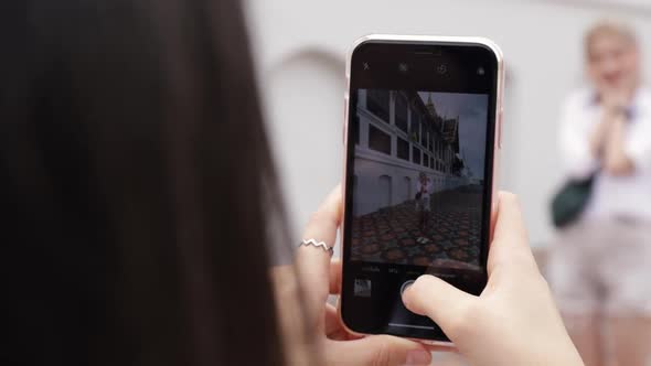 Close up Asian lesbian couple using smartphones taking a photo.