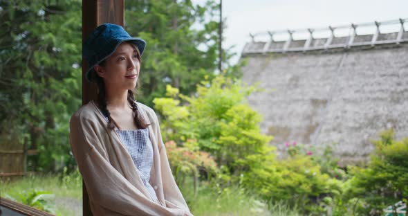 Woman sit at the wooden Japanese house