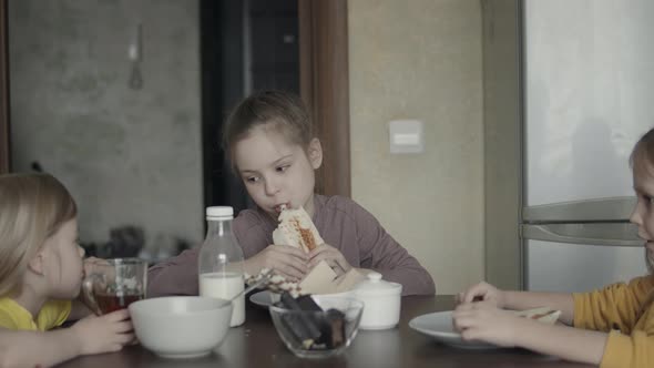 Children Have Breakfast at Home in the Kitchen