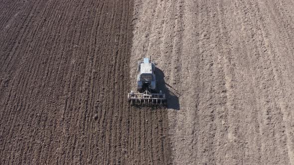 Aerial View of a Tractor That Plows the Land for Sowing