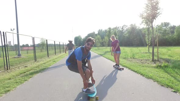 Happy young people having fun skateboarding