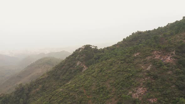 Drone Flight Over Mountain Under Misty Sky