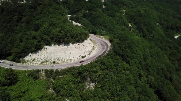 Aerial View From Above of Curve Road with a Car on the Mountain with Green Forest in Russia