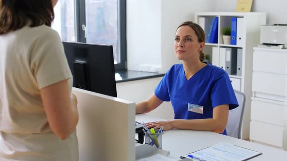 Doctor with Computer and Patient at Hospital