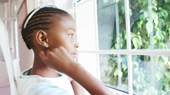 Girl in fairy costume looking through window 4k