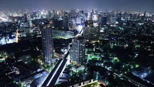 Time lapse view of business area in Bangkok, Thailand, showing buildings and traffic in night time