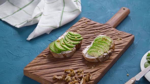 Healthy Eating Concept. Toast with Avocado Cream on the Wooden Board