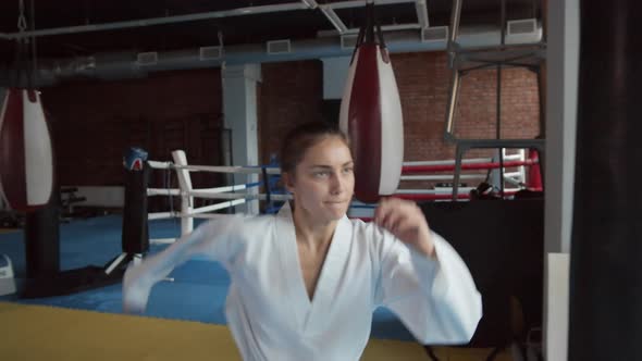 Skillful Female Caucasian Kickboxer Practicing Kicks