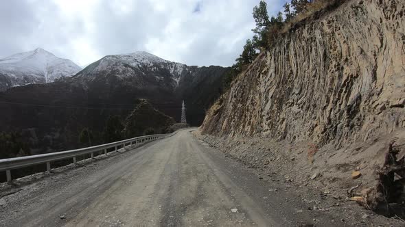 Off road car running on snowing mountain trail on winter day