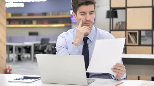 Pensive Businessman Reading Contract