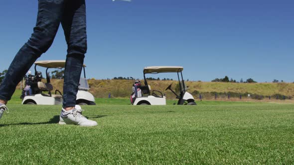 Caucasian senior woman practicing golf at golf course on a bright sunny day